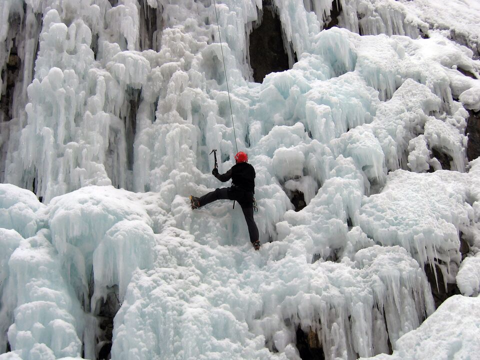 A climber uses ice picks to navigate the ice pillars and bulges at Ouray Ice Park in Ouray, CO. 