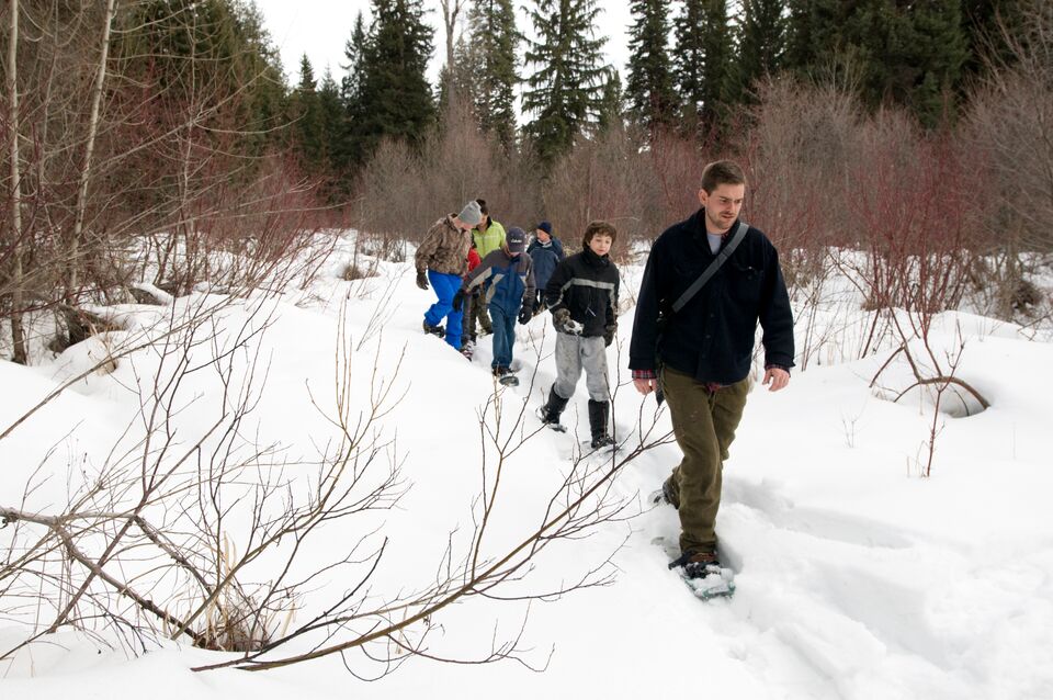 A teacher leads an after-school class in ecology on a snowshoeing adventure in the Swan Valley, MT.